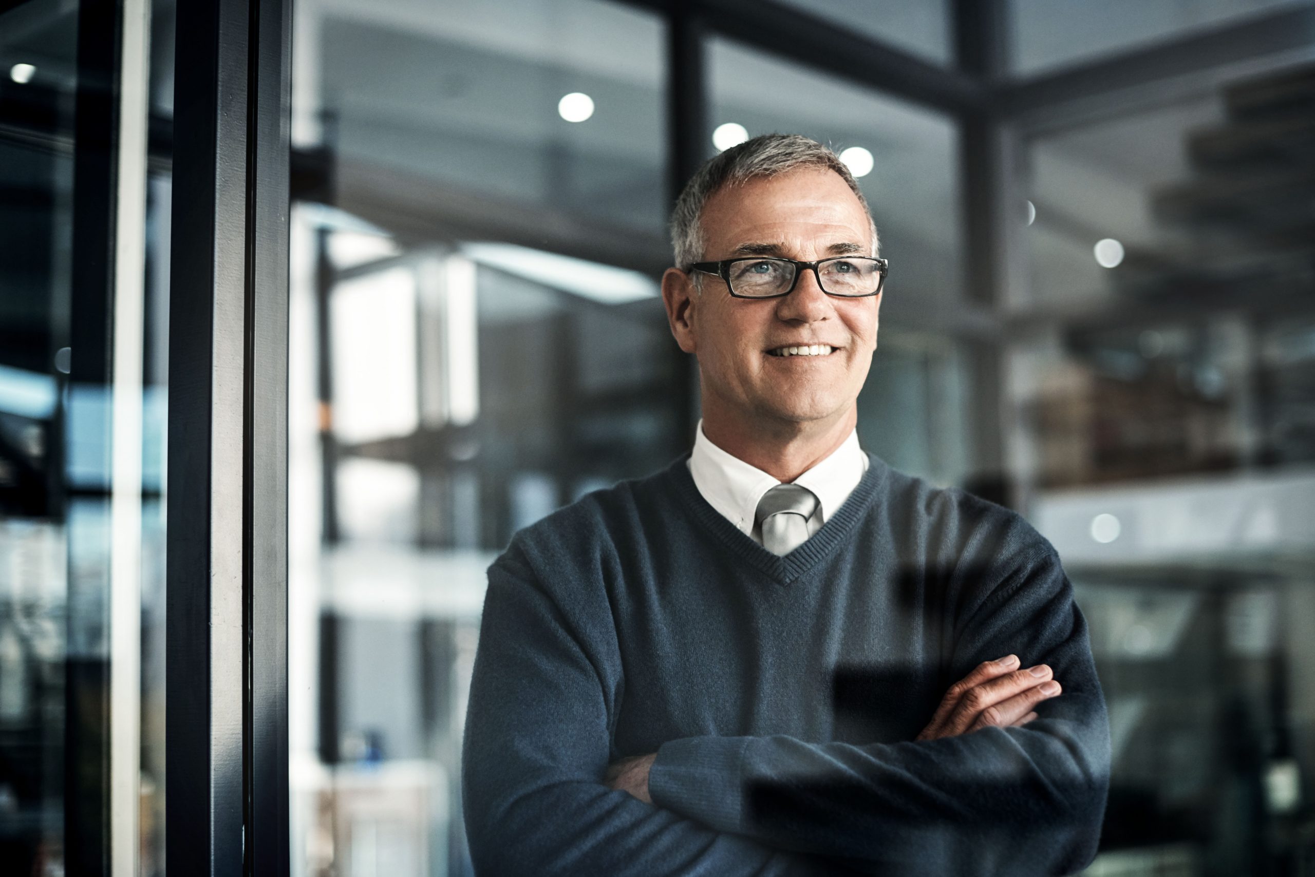 Shot of a mature businessman looking thoughtful while working late in an office